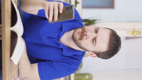 Vertical-video-of-Disappointed-man-in-messaging.